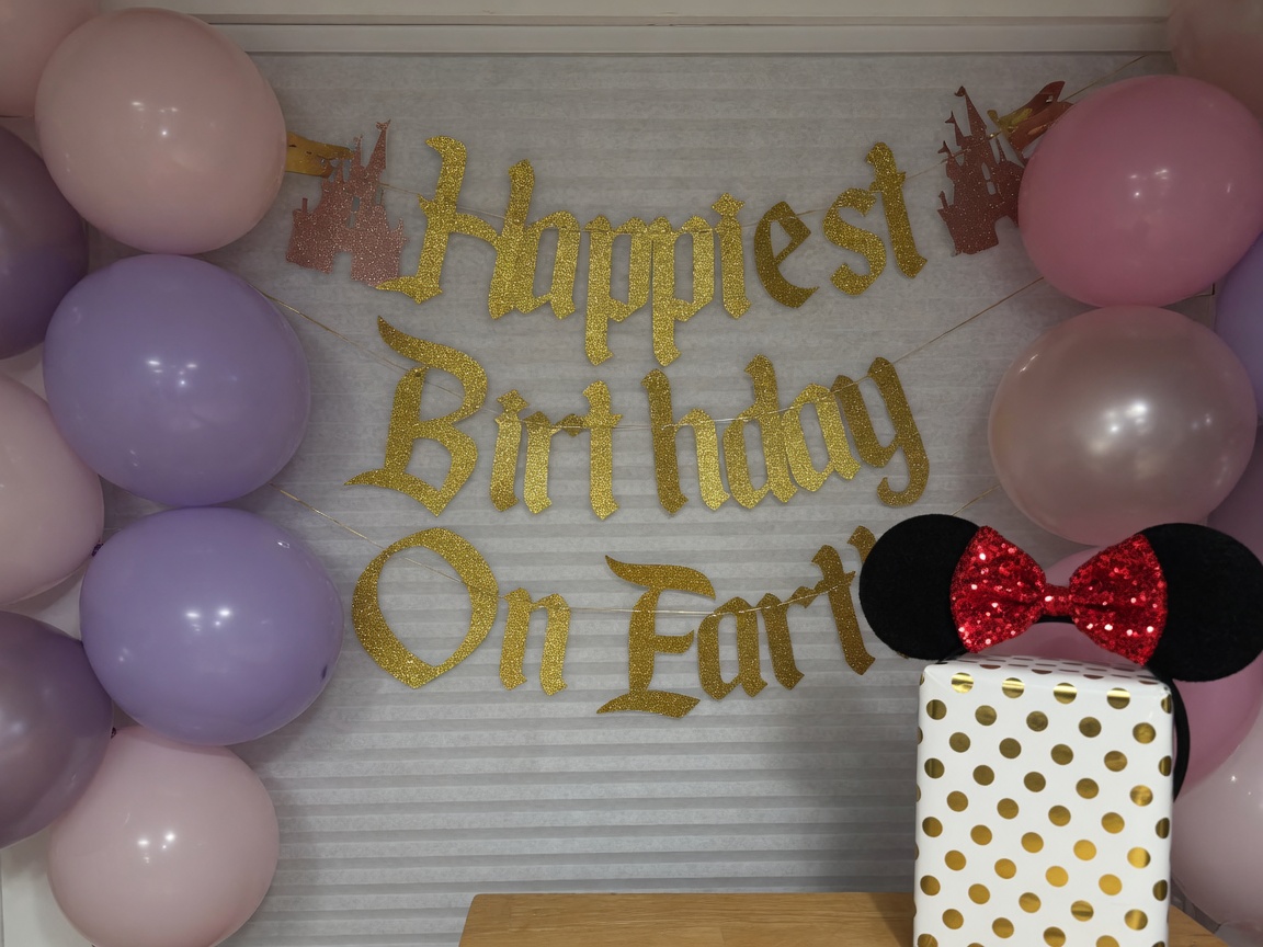 Happiest Birthday on Earth balloon and banner surprise wall with Minnie ears gift